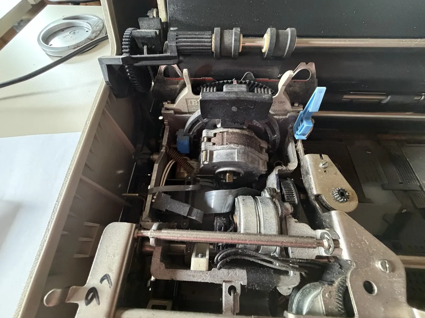 The Wheelwriter carrier assembly with the cover removed, showing the carrier rail, drive gears and the stepper motor bracket
