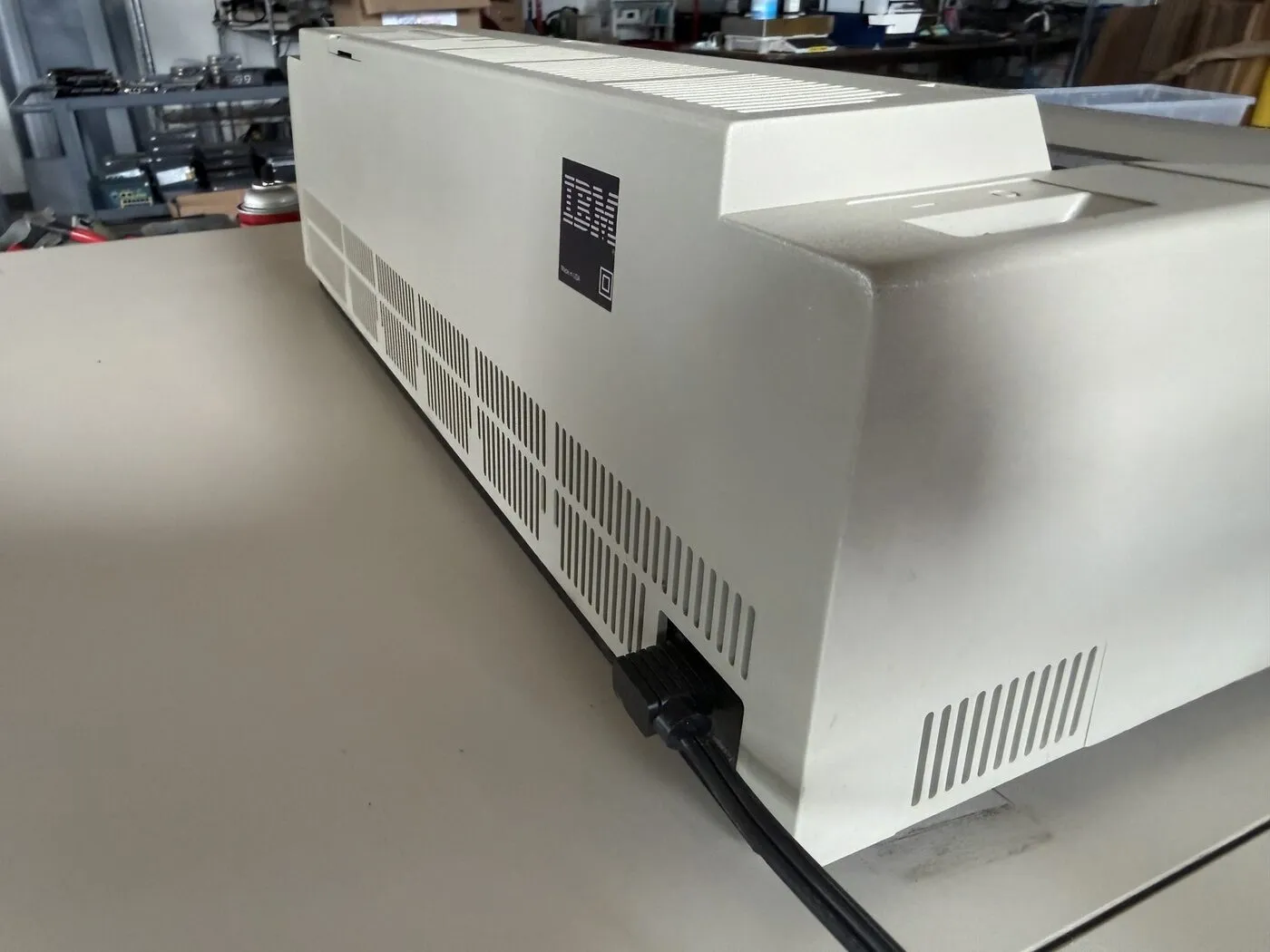 Rear of an IBM Wheelwriter 6 on the bench, showing the ventilation grille and the black specification plate above the power inlet